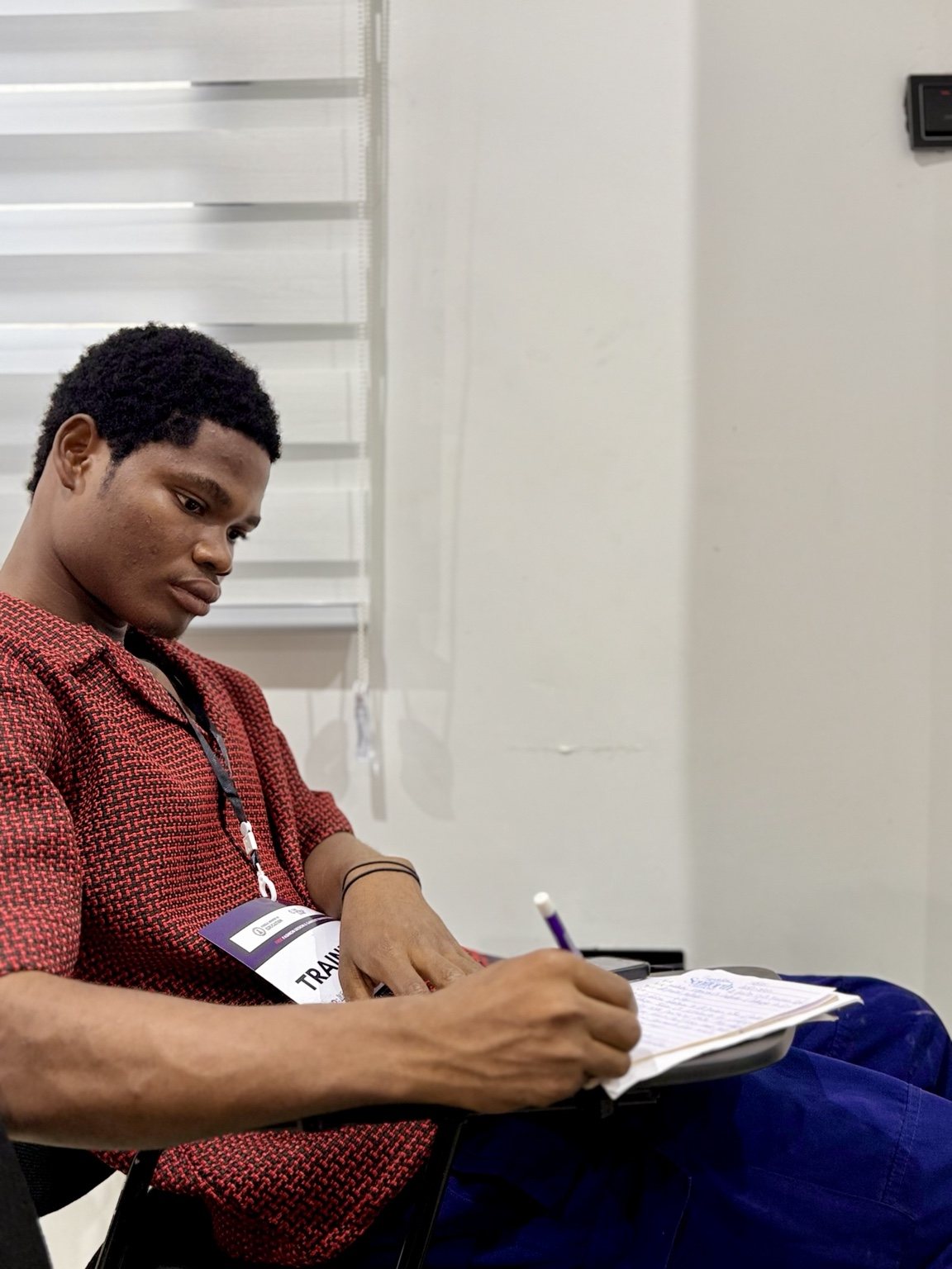 T-VET trainee taking notes during onboarding